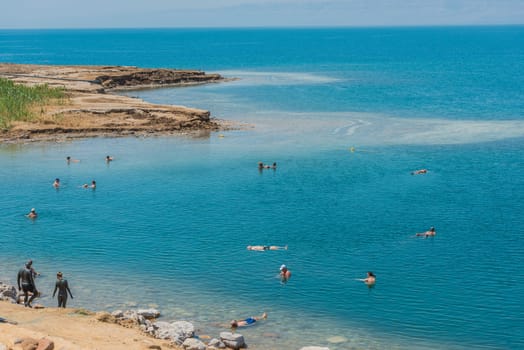 Dead Sea, Jordan - May 6, 2013 people swimming bathing in Dead Sea Jordan