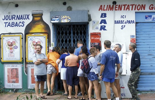 people go shoping bevor a tropical storm in the town of  St Gilles les Bains  on the Island of La Reunion in the Indian Ocean in Africa.