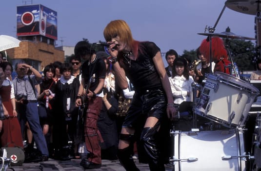 a Japanese Youth Punk Band plays on a square in the City of Tokyo in Japan in Asia,....