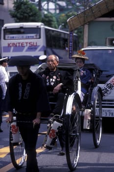a Riksha at the big festival in the Asakusa Senso Ji temple in the city center of Tokyo in Japan in Asia,....