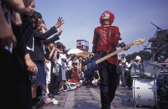 a Japanese Youth Punk Band plays on a square in the City of Tokyo in Japan in Asia,....