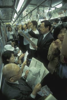 people i a train in the City centre of Tokyo in Japan in Asia,....