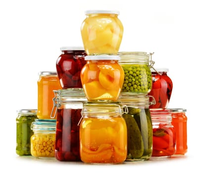 Jars with pickled vegetables, fruity compotes and jams isolated on white background. Preserved food