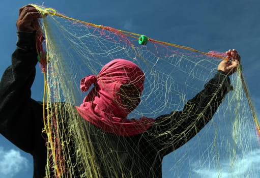 A fisherman in the water landscape around the capital Bandar Seri Begawan in the kingdom of Brunei Darussalam on Borneo in South East Asia.