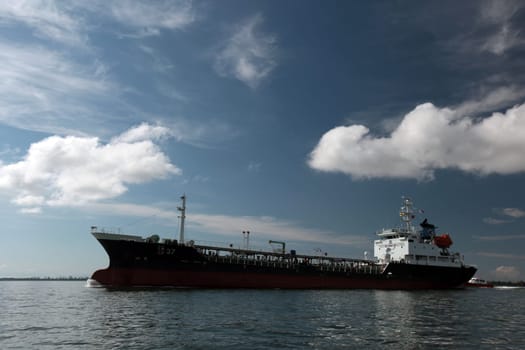 a oil freighter ship at the coast near the city of Bandar seri Begawan in the country of Brunei Darussalam on Borneo in Southeastasia.