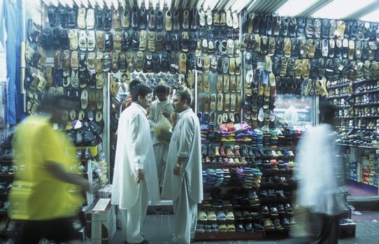 a shoe shop the souq or Market in the old town in the city of Dubai in the Arab Emirates in the Gulf of Arabia.