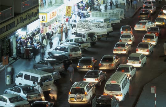 a road at night in the old town in the city of Dubai in the Arab Emirates in the Gulf of Arabia.