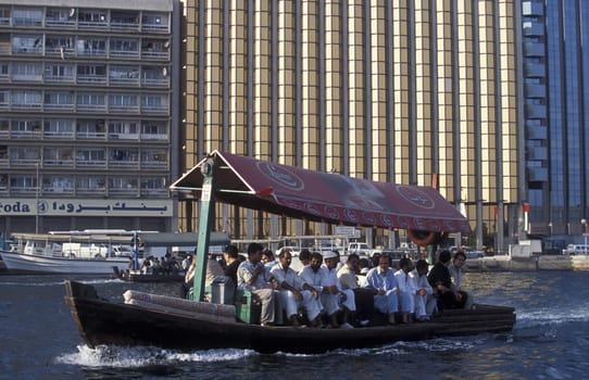 a city boat and ferry on the Dubai creek in the old town in the city of Dubai in the Arab Emirates in the Gulf of Arabia.