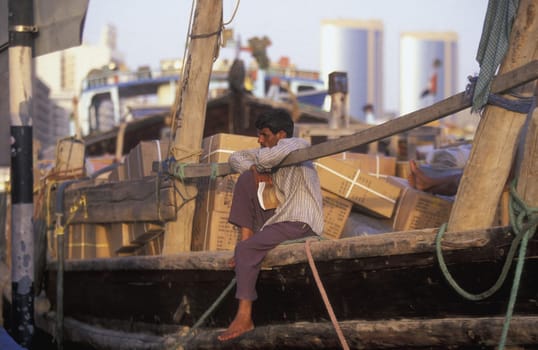 Import and export goods at the harbour at the Dubai creek in the old town in the city of Dubai in the Arab Emirates in the Gulf of Arabia.