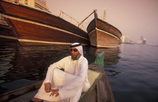 a city boat and ferry on the Dubai creek in the old town in the city of Dubai in the Arab Emirates in the Gulf of Arabia.