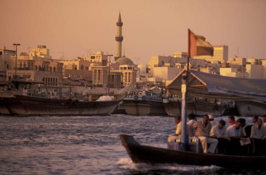 a city boat and ferry on the Dubai creek in the old town in the city of Dubai in the Arab Emirates in the Gulf of Arabia.