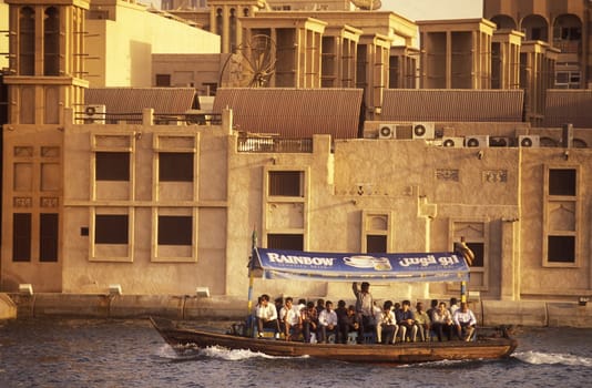 a city boat and ferry on the Dubai creek in the old town in the city of Dubai in the Arab Emirates in the Gulf of Arabia.