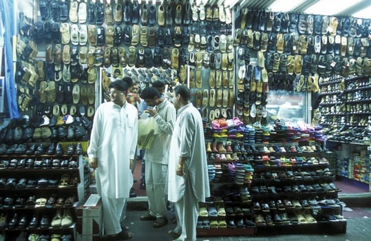 a shoe shop the souq or Market in the old town in the city of Dubai in the Arab Emirates in the Gulf of Arabia.