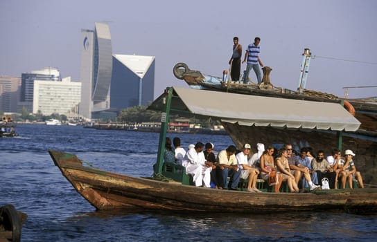 a city boat and ferry on the Dubai creek in the old town in the city of Dubai in the Arab Emirates in the Gulf of Arabia.
