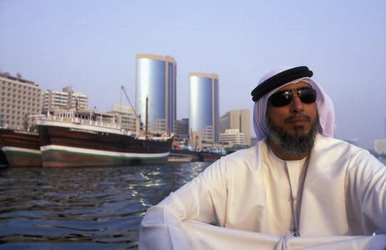 a city boat and ferry on the Dubai creek in the old town in the city of Dubai in the Arab Emirates in the Gulf of Arabia.