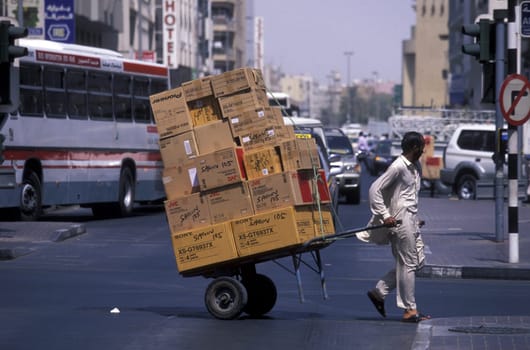 Import and export goods at the harbour at the Dubai creek in the old town in the city of Dubai in the Arab Emirates in the Gulf of Arabia.