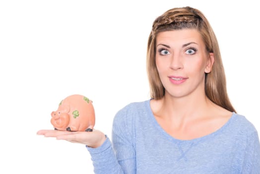 Portrait of a young woman with a piggy bank against a white background