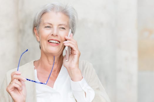 Smile senior citizen with smartphone