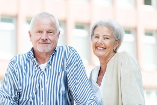 Active senior couple against an urban background