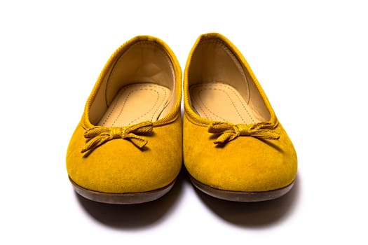 yellow female shoes closeup view from above on white background