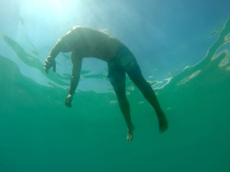 Man drowning viewed from below underwater