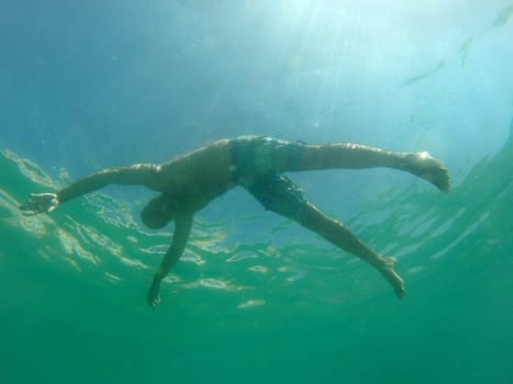 Man drowning viewed from below underwater
