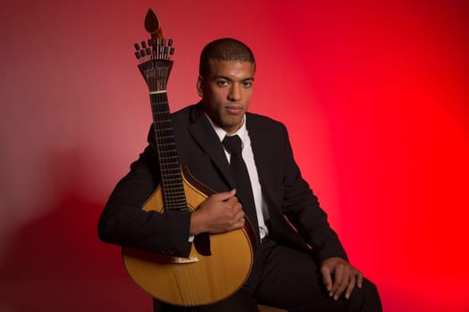 fado musician with a portuguese guitar, studio