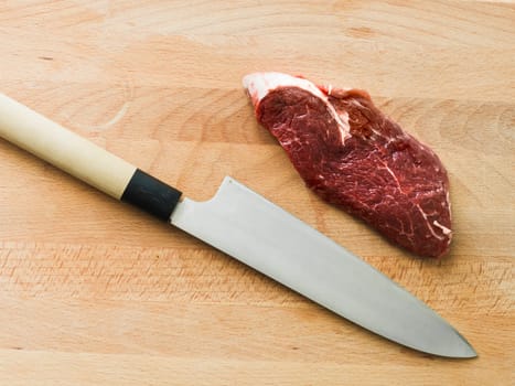 chopped piece of beef on a wooden table