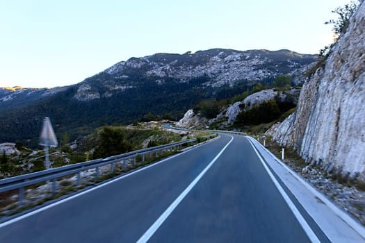 Turn of mountain highway with blue sky and sea on a background
