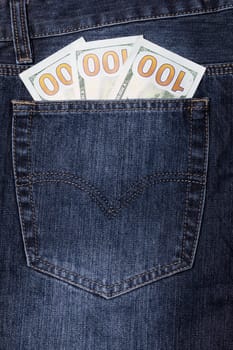 Several twenty dollar bills in the pocket of a pair of jeans