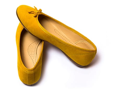 yellow female shoes closeup view from above on white background