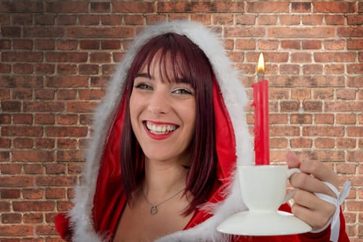 a sexy attractive young female Santa Claus with candle