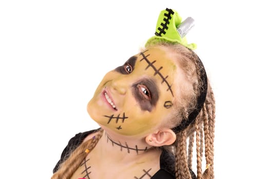 Girl with face-paint and Halloween monster costume isolated in white