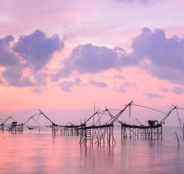 Beautiful sunrise seascape with Chinese fishing nets or shore operated lift nets in Phatthalung, Thailand