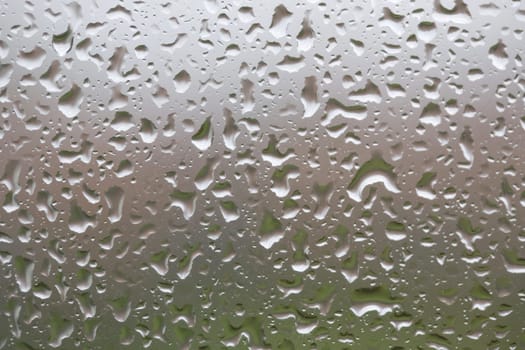 Glass surface with water drops in a rainy day