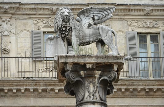 St. Mark's Lion, symbol of the Republic of Venice on a white marble column at the Piazza delle Erbe in Verona, Italy.