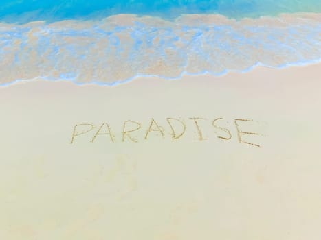 The inscription on and from the sand Paradise