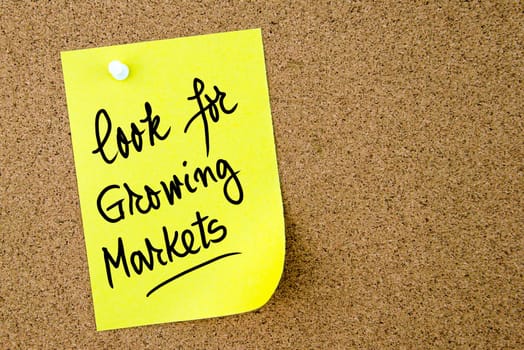 Look For Growing Markets text written on yellow paper note pinned on cork board with white thumbtack. Business concept image with copy space available