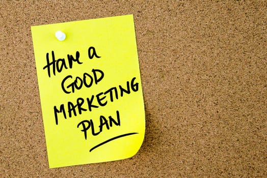 Have A Good Marketing Plan text written on yellow paper note pinned on cork board with white thumbtack. Business concept image with copy space available