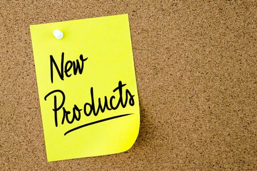New Products text written on yellow paper note pinned on cork board with white thumbtack. Business concept image with copy space available