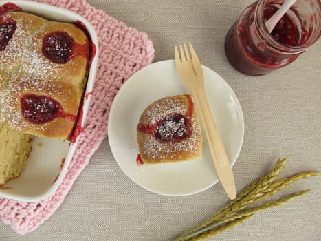 Homemade Buchteln with cranberry jam and icing sugar