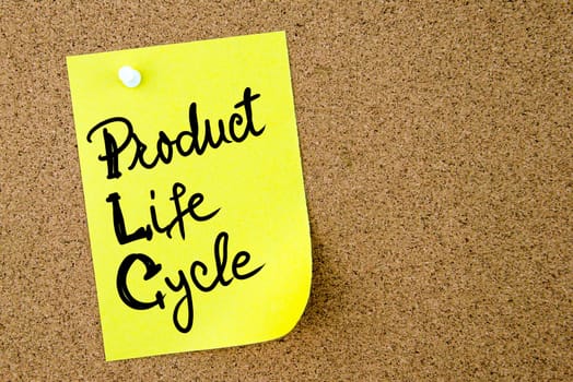 Product Life Cycle text written on yellow paper note pinned on cork board with white thumbtack. Business concept image with copy space available