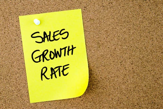 Sales Growth Rate text written on yellow paper note pinned on cork board with white thumbtack. Business concept image with copy space available