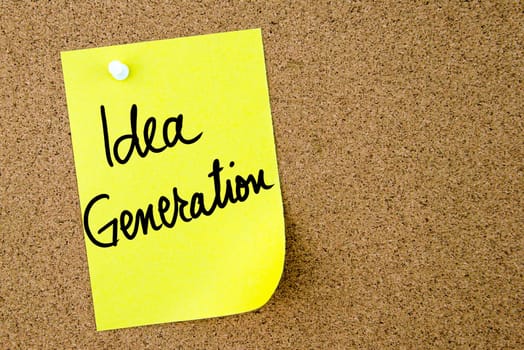 Idea Generation text written on yellow paper note pinned on cork board with white thumbtack. Business concept image with copy space available