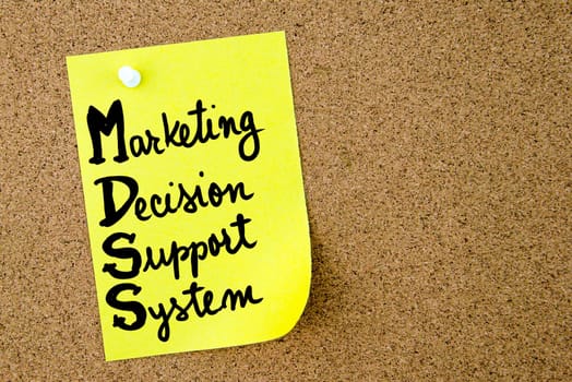 MDSS Marketing Decision Support System written on yellow paper note pinned on cork board with white thumbtack. Business concept image with copy space available