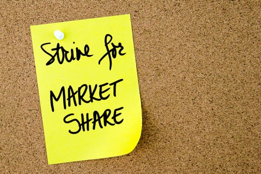 Strive For Market Share text written on yellow paper note pinned on cork board with white thumbtack. Business concept image with copy space available