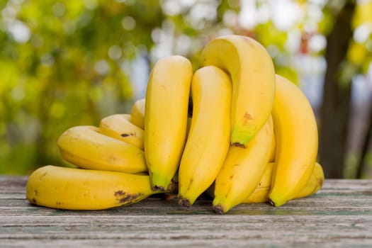 organic bananas on the wooden table at the farm, outdoor