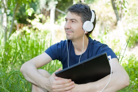 casual man working with a tablet pc, outdoor