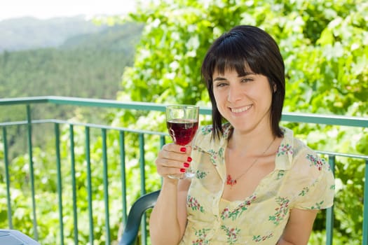woman drinking red wine in a vineyard, outdoor