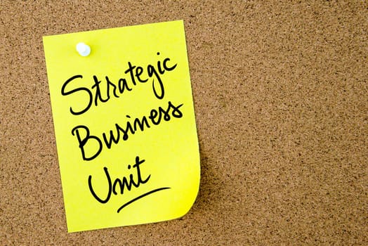 Strategic Business Unit text written on yellow paper note pinned on cork board with white thumbtack. Business concept image with copy space available